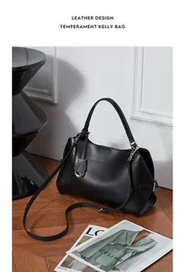 Détail d'un sac à main en cuir noir structuré avec garniture argentée et bandoulière