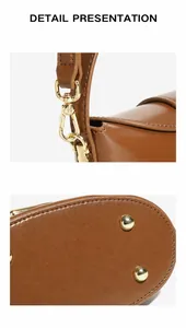 Detail view of detachable gold hardware hooks and protective bottom studs on leather bag