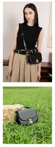 Detail of black leather saddle bag with gold hardware and adjustable strap on a model