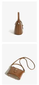 Detail of brown leather bucket bag showing side profile and gold anti-wear base studs
