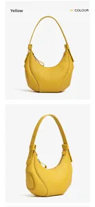 Dettaglio borsa hobo in pelle gialla con cuciture a vista e cerniera metallica argento