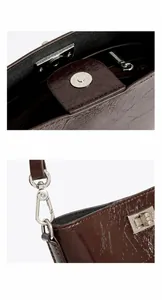 Détail du fermoir magnétique argenté et du crochet pivotant sur le sac en cuir ciré