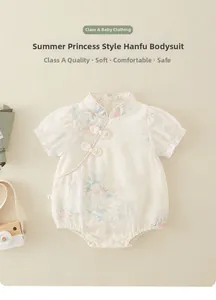 Close-up of baby romper with traditional Chinese style frog buttons and floral print