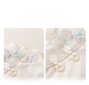 Detail view of retro Chinese style baby bodysuit featuring floral satin and knot buckle