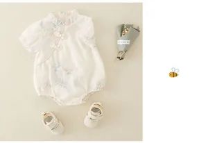 Detail of baby romper with Chinese collar, traditional knots and floral print