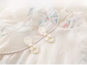 Close-up of traditional Chinese stand collar with handmade white frog buttons
