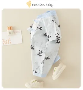 Detailed flat lay of light blue baby romper with panda prints and traditional knots
