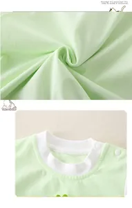 Detail of soft cotton baby romper with white ribbed crew neck and shoulder resin buttons