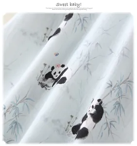 Detailed view of soft baby romper fabric with cute panda and bamboo ink print patterns
