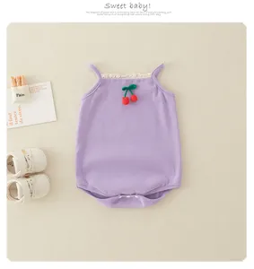Detail of purple cotton baby romper with knit cherry decor and lace trim collar