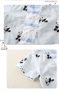 Detailed close-up of newborn panda romper with traditional buttons and soft cotton texture