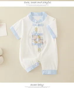 Detail of newborn cotton romper featuring traditional Chinese knots and embroidery