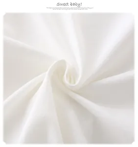 Detail shot of soft white 100% cotton fabric with natural texture for baby rompers