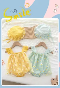 Detail of baby rompers with floral embroidery, ruffles, and matching sun hats in pastel colors