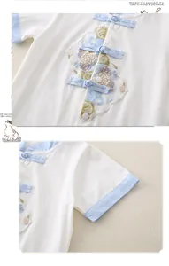 Detail of baby cotton romper with traditional Chinese buttons and flower embroidery