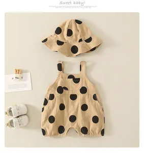Flat lay of baby summer set featuring polka dot romper and matching sun hat