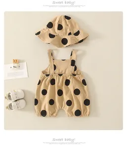Detailed view of beige polka dot baby romper set with matching bucket sun hat