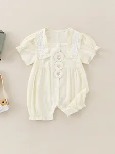 Sweet cream-colored baby girl romper with floral embroidery and lace sleeve detail