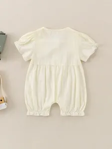 Sweet beige baby girl cotton romper with puffed sleeves and ruffled leg openings