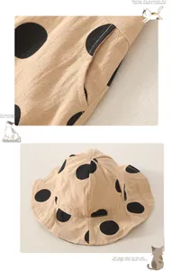 Detail of baby wide brim sun hat and pocket in beige cotton fabric with black polka dots