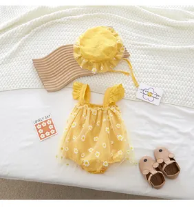 Flat lay of yellow sunflower baby romper with matching sun hat and mouse sandals