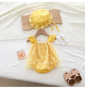 Close-up of yellow baby romper with white daisy tulle and matching ruffle sun hat