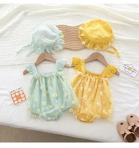 Detailed flat lay of baby rompers with daisy embroidery and matching sun hats