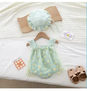 Detail of mint green baby girl romper with daisy embroidery and lace ruffle sleeves
