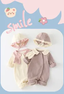 Detail of newborn cotton rompers featuring rabbit ear collars and snap buttons