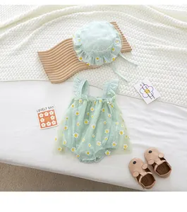 Flat lay of baby girl green daisy romper with matching sun hat and ruffle mesh details
