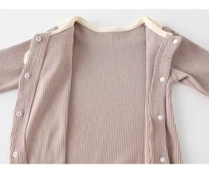 Detailed close-up of ribbed cotton baby romper featuring soft fabric and snap fasteners