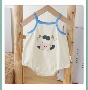 Detail of baby cotton bodysuit featuring a cartoon cow print and convenient bottom snaps