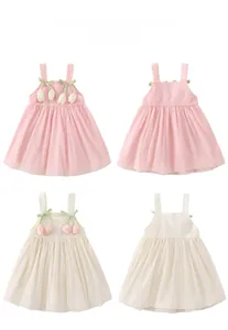 Detail of sweet toddler sun dresses with tulip appliques in pink and ivory color display