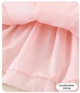 Detail view of the soft layered tulle fabric and comfortable lining on a pink summer dress