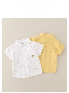 Detail of two kids short sleeve shirts with cute cartoon bear prints and front pockets