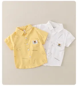 Detail of kids short sleeve shirts with bear prints and chest pocket on cotton fabric