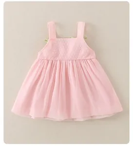 Detail of baby pink summer dress with knit bodice and light green bow shoulder straps