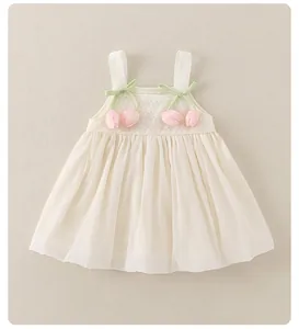 Detail of pink tulip applique and green ribbon bow on white textured baby girl dress