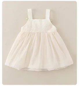 Detail of baby girl floral dress with green bows and intricate lace crochet bodice