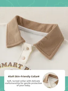 Détail d'un polo pour bébé avec col marron, boutons bicolores et imprimé Smart