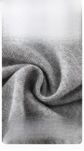 Close-up of skin-friendly grey knitted fabric showing soft combed cotton texture