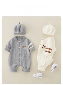 Detailed view of baby knitted romper set with bear embroidery and matching accessories