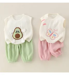 Détail de deux ensembles en coton sans manches pour bébé fille avec patchs avocat et papillon