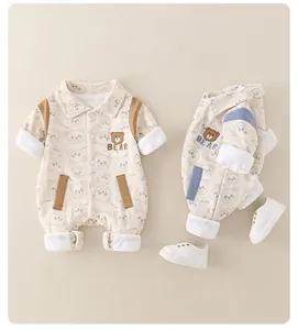 Detail of baby cotton romper featuring cute bear embroidery and stylish shirt collar design
