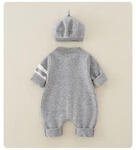 Detailed view of grey baby knit romper with matching beret and white sleeve stripes