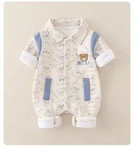Detail of baby cotton romper featuring 3D bear embroidery and blue shoulder accents