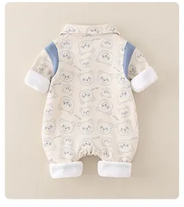 Detail of baby cotton romper featuring blue cartoon bear print and HSTT KIDS lettering