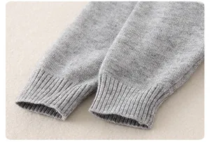Detail view of the ribbed knit cuffs on a soft gray newborn jumpsuit for spring