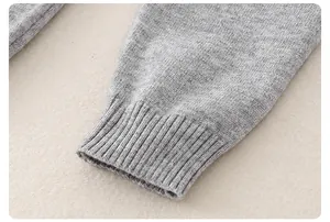 Close-up of light gray knitted sleeve cuff with refined ribbed texture for baby bodysuit