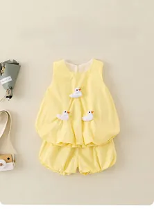 Flat lay of baby girl sleeveless cotton set featuring 3D white duck ornaments and bloomer shorts